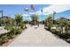 Inviting community entrance with flag poles, well-manicured landscaping, and brick pathway at 10415 Andele Ave, Las Vegas, NV 89166