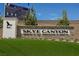 The Skye Canyon community entrance sign features a stone base and monument with lush green landscaping at 10415 Andele Ave, Las Vegas, NV 89166