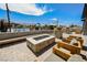 Comfortable outdoor seating surrounds a stylish fire pit, creating a cozy community gathering spot at 10415 Andele Ave, Las Vegas, NV 89166