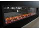 Close-up of a linear electric fireplace with glowing embers and crystal accents at 10415 Andele Ave, Las Vegas, NV 89166
