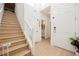 Entryway with a wood staircase and views of the bathroom, front door, and stairs at 10415 Andele Ave, Las Vegas, NV 89166