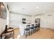 Stylish kitchen with white cabinetry, quartz countertops, stainless steel appliances, and a breakfast bar at 10415 Andele Ave, Las Vegas, NV 89166