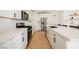 Contemporary kitchen with white cabinets, stainless steel appliances, and sleek countertops at 10415 Andele Ave, Las Vegas, NV 89166