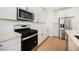 Stylish kitchen with white cabinets, modern appliances, and light wood flooring at 10415 Andele Ave, Las Vegas, NV 89166