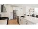 Modern kitchen with stainless steel appliances, white cabinets, and a central island with bar stools at 10415 Andele Ave, Las Vegas, NV 89166