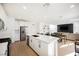 Bright kitchen with white cabinets, stainless steel appliances, and an open layout to the living area at 10415 Andele Ave, Las Vegas, NV 89166