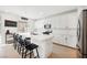 Modern kitchen with white cabinets, a quartz countertop island, and stainless steel appliances at 10415 Andele Ave, Las Vegas, NV 89166