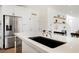 Bright kitchen with stainless steel refrigerator, quartz countertops and sleek black sink at 10415 Andele Ave, Las Vegas, NV 89166