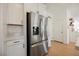 Modern kitchen featuring stainless steel refrigerator and white cabinets with contemporary hardware at 10415 Andele Ave, Las Vegas, NV 89166