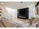 Bright living room featuring a linear fireplace, staircase, and neutral decor at 10415 Andele Ave, Las Vegas, NV 89166