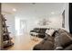 Open-concept living room featuring a large sectional sofa, wood floors, and stylish decor at 10415 Andele Ave, Las Vegas, NV 89166