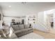 Bright open-concept living space featuring an adjacent kitchen and staircase at 10415 Andele Ave, Las Vegas, NV 89166
