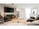 Cozy living room featuring a large TV and comfortable sectional sofa at 10415 Andele Ave, Las Vegas, NV 89166
