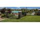 A fenced community pool area features lush grass, landscaping, and views of the pool beyond at 10415 Andele Ave, Las Vegas, NV 89166
