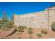 Cantaro community sign with stone base, lush landscaping, and mountain views, offering a welcoming entrance at 10415 Andele Ave, Las Vegas, NV 89166