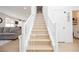 Bright, modern staircase with white railings and light wood flooring at 10415 Andele Ave, Las Vegas, NV 89166