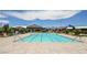 A clear, turquoise swimming pool is surrounded by lounge chairs in this inviting community space at 10415 Andele Ave, Las Vegas, NV 89166