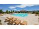 Relaxing lounge chairs and clear, inviting swimming pool highlight the community's recreational amenities at 10415 Andele Ave, Las Vegas, NV 89166