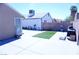 Backyard featuring a concrete patio, artificial turf, and brick walls for privacy at 115 Parrish Ln, Las Vegas, NV 89110