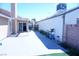 Concrete patio leading to sliding glass doors, surrounded by plants and artificial turf at 115 Parrish Ln, Las Vegas, NV 89110