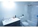 Bright bathroom featuring a vanity with a sink, toilet, and a shower-tub combo for convenience at 115 Parrish Ln, Las Vegas, NV 89110
