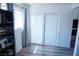 Well-lit bedroom highlighting sliding glass doors with blinds, neutral walls and light gray-toned flooring at 115 Parrish Ln, Las Vegas, NV 89110