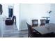 Dining room area with wood flooring, view to living room with modern furniture at 115 Parrish Ln, Las Vegas, NV 89110
