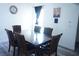 Dining room with a large wooden table, seating for six, and views to backyard at 115 Parrish Ln, Las Vegas, NV 89110
