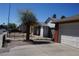 View of home from driveway showing the garage and landscaping at 115 Parrish Ln, Las Vegas, NV 89110