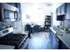 Modern kitchen boasting dark blue cabinets, gray mosaic backsplash, and sleek stainless steel appliances at 115 Parrish Ln, Las Vegas, NV 89110