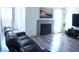Bright living room featuring a decorative fireplace, neutral paint, and modern gray-toned flooring at 115 Parrish Ln, Las Vegas, NV 89110