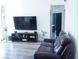 Open living area showcasing neutral walls, light wood floors, and a large wall-mounted television at 115 Parrish Ln, Las Vegas, NV 89110
