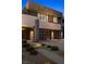 Contemporary two-story home with desert landscaping leading to a walkway and two-car garage at 1172 Monte De Luz Way, Henderson, NV 89012