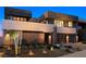 Modern two-story home featuring a landscaped front yard, desert foliage and a two car garage at 1172 Monte De Luz Way, Henderson, NV 89012