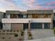 Contemporary two-story home with desert landscaping leading to a walkway and two-car garage at 1172 Monte De Luz Way, Henderson, NV 89012