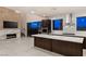 Contemporary kitchen with island, modern appliances, and outdoor living space access at 1172 Monte De Luz Way, Henderson, NV 89012