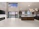 Open-concept kitchen with island, modern appliances, and access to outdoor living space at 1172 Monte De Luz Way, Henderson, NV 89012