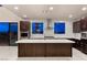 Contemporary kitchen with a center island, modern stainless steel appliances, and dark wood cabinetry at 1172 Monte De Luz Way, Henderson, NV 89012