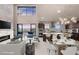 Open concept living room and kitchen with luxury decor, fireplace and city views at 1172 Monte De Luz Way, Henderson, NV 89012