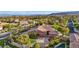 Aerial view of a community with lush landscaping, pools, and mountain views at 11730 Stonewall Springs Ave, Las Vegas, NV 89138