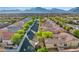 Aerial view of a residential neighborhood with lush landscaping and mountain views at 11730 Stonewall Springs Ave, Las Vegas, NV 89138