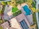 Aerial view of a home showcasing a pool, basketball court, and lush landscaping at 11730 Stonewall Springs Ave, Las Vegas, NV 89138