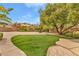 Lush backyard featuring mature trees and a well-maintained artificial grass area at 11730 Stonewall Springs Ave, Las Vegas, NV 89138
