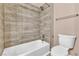 Bathroom with a tile shower-tub combination and a toilet at 11730 Stonewall Springs Ave, Las Vegas, NV 89138
