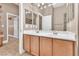 Bathroom featuring double sinks, cabinet storage and neutral color palette at 11730 Stonewall Springs Ave, Las Vegas, NV 89138