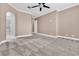 A spacious bedroom with a ceiling fan, neutral walls, and carpet at 11730 Stonewall Springs Ave, Las Vegas, NV 89138
