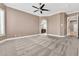 Spacious bedroom offers neutral colors, a ceiling fan, and views to the hallway and bathroom at 11730 Stonewall Springs Ave, Las Vegas, NV 89138