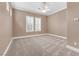 Spacious bedroom featuring plush carpeting, plantation shutters, and a ceiling fan at 11730 Stonewall Springs Ave, Las Vegas, NV 89138