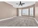 Bedroom with plantation shutters, ceiling fan, and backyard access offer a comfortable space at 11730 Stonewall Springs Ave, Las Vegas, NV 89138