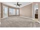 Bedroom with shutters, ceiling fan, and access to the backyard offers plenty of natural light at 11730 Stonewall Springs Ave, Las Vegas, NV 89138